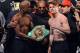 LAS VEGAS, NV - SEPTEMBER 13: CEO of Mayweather Promotions Leonard Ellerbe (C) looks on as boxer Floyd Mayweather Jr. (L) tries to get boxer Canelo Alvarez (R) to hold a WBC belt as they pose during the official weigh-in for their bout at the MGM Grand Garden Arena on September 13, 2013 in Las Vegas, Nevada. The fighters will meet in a WBC/WBA 154-pound title fight on September 14 in Las Vegas. (Photo by Ethan Miller/Getty Images)