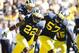 Sep 14, 2013; Ann Arbor, MI, USA; Michigan Wolverines safety Jarrod Wilson (22) receives congratulations from defensive end Frank Clark (57) after making an interception in the end zone to stop the Akron Zips from scoring in the second half at Michigan Stadium. Mandatory Credit: Rick Osentoski-USA TODAY Sports