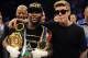 Sep 14, 2013; Las Vegas, NV, USA; Floyd Mayweather Jr (left) and Justin Bieber appear in the ring after Mayweather defeated Canelo Alvarez by a majority decision at their WBC and WBA super welterweight titles fight at MGM Grand Garden Arena. Mandatory Credit: Jayne Kamin-Oncea-USA TODAY Sports