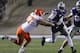 MANHATTAN, KS - NOVEMBER 03: Quarterback Daniel Sams #4 of the Kansas State Wildcats looks for some running space against Alex Elkins #37 of the Oklahoma State Cowboys in the third quarter at Bill Snyder Family Football Stadium on November 3, 2012 in Manhattan, Kansas. (Photo by Ed Zurga/Getty Images)
