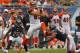Sep 8, 2013; Chicago, IL, USA; Cincinnati Bengals tight end Tyler Eifert (center) makes a catch between Chicago Bears cornerback Tim Jennings (left) and Bears outside linebacker Lance Briggs (right) during the second half at Soldier Field. Chicago won 24-21. Mandatory Credit: Dennis Wierzbicki-USA TODAY Sports