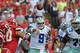 KANSAS CITY, MO - SEPTEMBER 15: Quarterback Tony Romo #9 of the Dallas Cowboys hurries his throw against pressure from defensive end Mike DeVito #70 of the Kansas City Chiefs during the first half on September 15, 2013 at Arrowhead Stadium in Kansas City, Missouri. Kansas City defeated Dallas 17-16. (Photo by Peter Aiken/Getty Images)