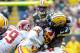 Sep 15, 2013; Green Bay, WI, USA; Washington Redskins safety Brandon Meriweather hits Green Bay Packers running back Eddie Lacy in the first quarter at Lambeau Field. Lacy was hurt on the play and did not return for the rest of the game. Mandatory Credit: Benny Sieu-USA TODAY Sports