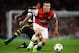 LONDON, ENGLAND - AUGUST 27: Jack Wilshere (R) of Arsenal holds off the challenge of Selcuk Sahin of Fenerbahce during the UEFA Champions League Play Off Second leg match between Arsenal FC and Fenerbahce SK at Emirates Stadium on August 27, 2013 in London, England. (Photo by Michael Regan/Getty Images)
