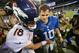 EAST RUTHERFORD, NJ - SEPTEMBER 15: Quarterback Peyton Manning #18 of the Denver Broncos and brother quarterback Eli Manning #10 of the New York Giants shake hands at the end of the Denver Broncos 41-23 win over the New York Giants at MetLife Stadium on September 15, 2013 in East Rutherford, New Jersey. (Photo by Ron Antonelli/Getty Images)