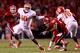 RALEIGH, NC - SEPTEMBER 19: Robert Caldwell #48 of the North Carolina State Wolfpack tries to tackle Tajh Boyd #10 of the Clemson Tigers during their game at Carter-Finley Stadium on September 19, 2013 in Raleigh, North Carolina. (Photo by Streeter Lecka/Getty Images)