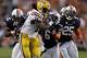 Sep 22, 2012; Auburn, AL, USA; LSU Tigers running back Spencer Ware (11) eludes Auburn Tigers defenders Joshua Holsey (15), Jonathon Mincy (6), and Daren Bates (6) during the first quarter at Jordan-Hare Stadium. Mandatory Credit: John Reed-USA TODAY Sports