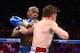 LAS VEGAS, NV - SEPTEMBER 14: (L-R) Floyd Mayweather Jr. throws a left at Canelo Alvarez during their WBC/WBA 154-pound title fight at the MGM Grand Garden Arena on September 14, 2013 in Las Vegas, Nevada. (Photo by Al Bello/Getty Images)