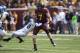 Sep 21, 2013; Minneapolis, MN, USA; Minnesota Golden Gophers quarterback Mitch Leidner (7) breaks away from a tackle by San Jose State Spartans safety Damon Ogburn (6) in the second half at TCF Bank Stadium. The Gophers won 43-24. Mandatory Credit: Jesse Johnson-USA TODAY Sports