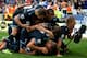 CARDIFF, WALES - SEPTEMBER 22: Paulinho of Tottenham celebrates with Kyle Naughton (C), Lewis Holtby (R) and their team-mates after scoring the winning goal during the Barclays Premier League match between Cardiff City and Tottenham Hotspur at Cardiff City Stadium on September 22, 2013 in Cardiff, Wales. (Photo by Ben Hoskins/Getty Images)