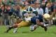 SOUTH BEND, IN - SEPTEMBER 21: Arjen Colquhoun #36 of the Michigan State Spartans brings down eoge Atkinson III #4 of the Notre Dame Fighting Irish at Notre Dame Stadium on September 21, 2013 in South Bend, Indiana. Notre Dame defeated Michigan State 17-13. (Photo by Jonathan Daniel/Getty Images)