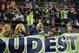 Sep 15, 2013; Seattle, WA, USA; Seattle Seahawks fan Chris Wright (in green sleeve) cheers his team against the San Francisco 49ers during the fourth quarter at CenturyLink Field. Mandatory Credit: Joe Nicholson-USA TODAY Sports