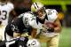 NEW ORLEANS, LA - AUGUST 16: Kenny Stills #84 of the New Orleans Saints is tackled by Tyvon Branch #33 and Tracy Porter #31 of the Oakland Raiders during a preseason game at the Mercedes-Benz Superdome on August 16, 2013 in New Orleans, Louisiana. (Photo by Stacy Revere/Getty Images)
