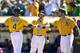 OAKLAND, CA - SEPTEMBER 22: Coco Crisp #4 of the Oakland Athletics is congratulated by teammates after hitting a three run home run against the Minnesota Twins during the second inning at O.co Coliseum on September 22, 2013 in Oakland, California. (Photo by Jason O. Watson/Getty Images)
