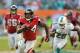 Sep 22, 2013; Miami Gardens, FL, USA; Atlanta Falcons fullback Jason Snelling (44) runs past Miami Dolphins cornerback Nolan Carroll (28) during the second half at Sun Life Stadium. Mandatory Credit: Steve Mitchell-USA TODAY Sports