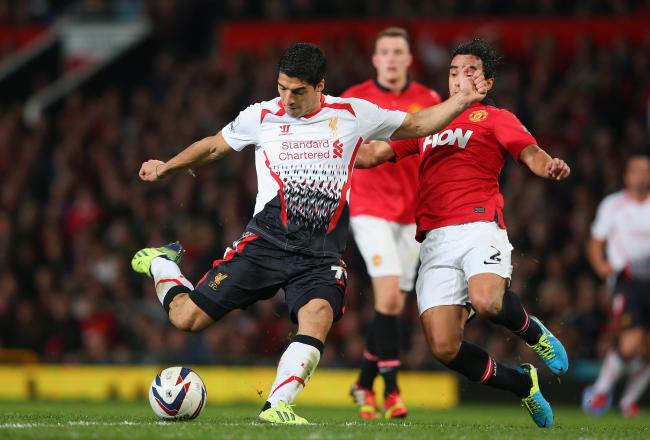 Hi-res-181804445-luis-suarez-of-liverpool-shoots-under-pressure-from_crop_north