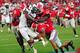 ATHENS, GA - SEPTEMBER 7: Shaq Roland #4 of the South Carolina Gamecocks is tackled by Tray Matthews #28, Amarlo Herrera #52 and Josh Harvey-Clemons #25 of the Georgia Bulldogs at Sanford Stadium on September 7, 2013 in Athens, Georgia. (Photo by Scott Cunningham/Getty Images)