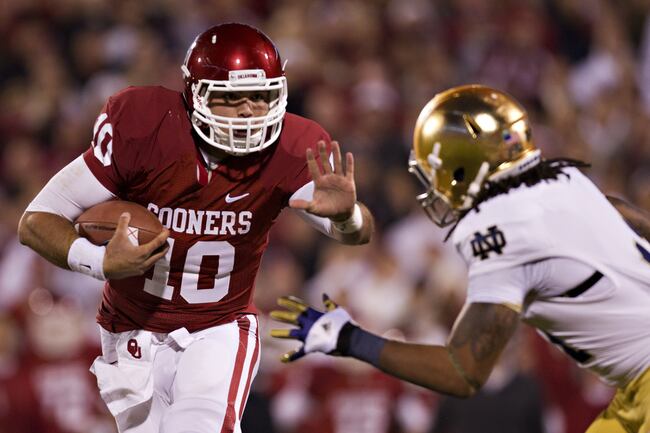 Hi-res-154851475-blake-bell-of-the-oklahoma-sooners-avoids-the-tackle-of_crop_north