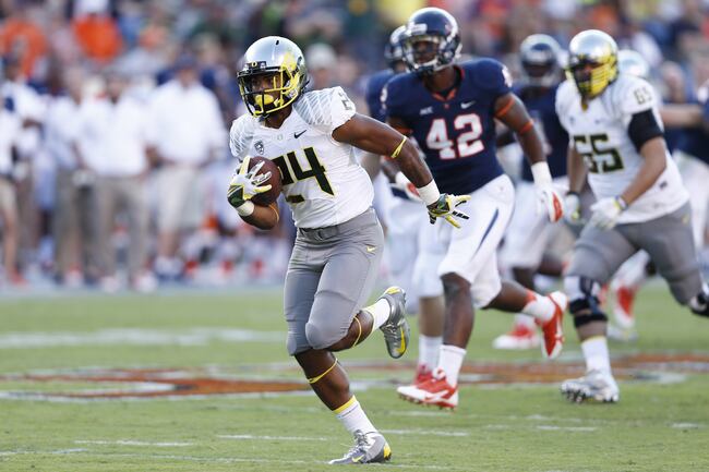 Hi-res-179977849-thomas-tyner-of-the-oregon-ducks-rushes-for-a-31-yard_crop_north