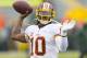Sep 15, 2013; Green Bay, WI, USA; Washington Redskins quarterback Robert Griffin III (10) throws a pass during warmups prior to the game against the Green Bay Packers at Lambeau Field. Mandatory Credit: Jeff Hanisch-USA TODAY Sports