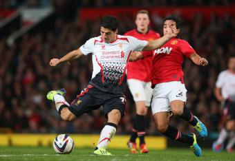 Hi-res-181804445-luis-suarez-of-liverpool-shoots-under-pressure-from_crop_north