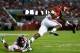 TUSCALOOSA, AL - SEPTEMBER 28: T.J. Yeldon #4 of the Alabama Crimson Tide leaps over Mike Hilton #28 of the Mississippi Rebels at Bryant-Denny Stadium on September 28, 2013 in Tuscaloosa, Alabama. (Photo by Kevin C. Cox/Getty Images)