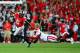 Sep 28, 2013; Columbus, OH, USA; Ohio State Buckeyes quarterback Braxton Miller (5) escapes a Wisconsin Badgers defender during the first quarter at Ohio Stadium. Mandatory Credit: Andrew Weber-USA TODAY Sports
