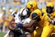 Sep 28, 2013; Morgantown, WV, USA; Oklahoma State Cowboys wide receiver Tracy Moore (87) is tackled by West Virginia Mountaineers linebacker Doug Rigg (47) during the first half at Milan Puskar Stadium. Mandatory Credit: Peter Casey-USA TODAY Sports