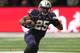 SEATTLE, WA - SEPTEMBER 28: Bishop Sankey #25 of the Washington Huskies runs past an Arizona Wildcat during the first quarter on September 28, 2013 at Husky Stadium in Seattle, Washington. (Photo by Kevin Casey/Getty Images)