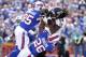 Sep 29, 2013; Orchard Park, NY, USA; Baltimore Ravens wide receiver Marlon Brown (14) catches a touchdown pass as Buffalo Bills defensive back Jim Leonhard (35) and defensive back Justin Rogers (26) defend during the first half at Ralph Wilson Stadium. Mandatory Credit: Kevin Hoffman-USA TODAY Sports