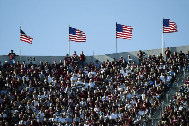 Hi-res-2032872-near-amerian-flags-waving-in-the-wind-fans-watch-the-game_crop_north