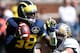 ANN ARBOR, MI - SEPTEMBER 14: Devin Gardner #98 of the Michigan Wolverines scrabbles away for the tackle of Nick Rossi #44 of the Akron Zips during the fourth quarter at Michigan Stadium on September 14, 2013 in Ann Arbor, Michigan. Michigan on the game 28-24. (Photo by Gregory Shamus/Getty Images)
