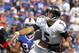 Sep 29, 2013; Orchard Park, NY, USA; Baltimore Ravens quarterback Joe Flacco (5) gets hit by Buffalo Bills defensive tackle Alan Branch (90) after a throw during the first half at Ralph Wilson Stadium. Mandatory Credit: Timothy T. Ludwig-USA TODAY Sports