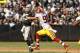 Sep 29, 2013; Oakland, CA, USA; Oakland Raiders quarterback Matt Flynn (15) throws the ball while being pursued by Washington Redskins outside linebacker Ryan Kerrigan (91) in the second quarter at O.co Coliseum. Mandatory Credit: Cary Edmondson-USA TODAY Sports