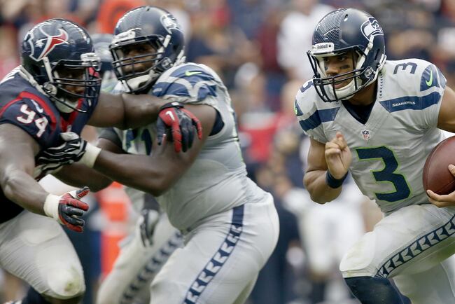 Hi-res-182388127-russell-wilson-of-the-seattle-seahawks-rashes-against_crop_north