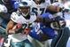 Dec 30, 2012; East Rutherford, NJ, USA; Philadelphia Eagles running back LeSean McCoy (25) fights off New York Giants defensive end Jason Pierre-Paul (90) during the first half at MetLife Stadium. Mandatory Credit: Jim O'Connor-USA TODAY Sports