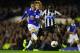 LIVERPOOL, ENGLAND - SEPTEMBER 30: Everton player Ross Barkley shoots past Mapou Yanga-Mbiiwa to score the second goal during the Barclays Premier League match between Everton and Newcastle United at Goodison Park on September 30, 2013 in Liverpool, England. (Photo by Stu Forster/Getty Images)