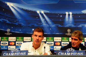 Hi-res-182582363-edin-dzeco-and-manuel-pellegrini-of-manchester-city_crop_north