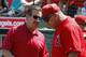 March 24, 2013; Tempe, AZ, USA; Los Angeles Angels manager Mike Scioscia (14) talks to owner Arte Moreno before a spring training game against the San Francisco Giants at Tempe Diablo Stadium. Mandatory Credit: Rick Scuteri-USA TODAY Sports