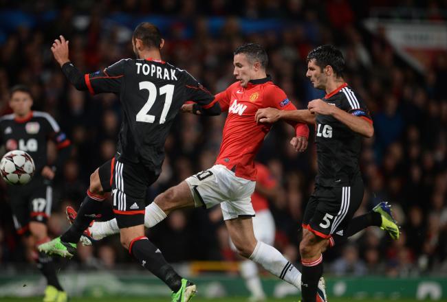 Hi-res-180899133-robin-van-persie-of-manchester-united-competes-with_crop_north