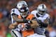 DENVER, CO - SEPTEMBER 23: Eric Decker #87 of the Denver Broncos makes a pass reception for a first down and is tackled by Charles Woodson #24 and Kevin Burnett #94 of the Oakland Raiders at Sports Authority Field at Mile High on September 23, 2013 in Denver, Colorado. The Broncos defeated the Raiders 37-21. (Photo by Doug Pensinger/Getty Images)