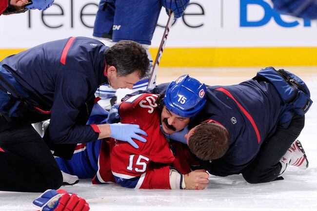 Hi-res-182617732-george-parros-of-the-montreal-canadiens-is-tended-to-by_crop_north