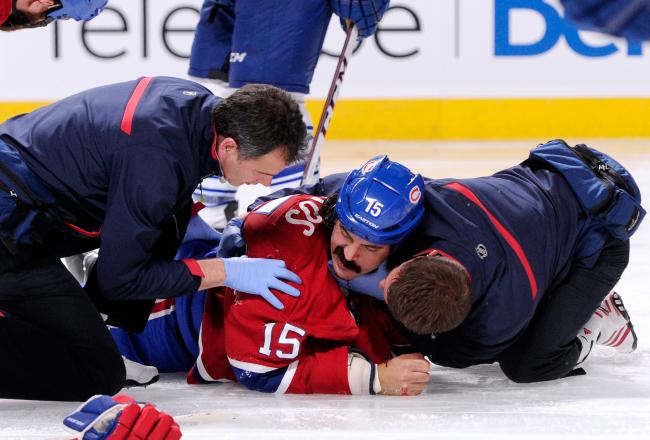 Hi-res-182617732-george-parros-of-the-montreal-canadiens-is-tended-to-by_crop_north