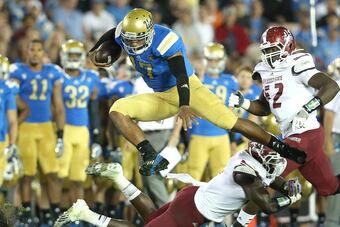 Hi-res-181516010-quarterback-brett-hundley-of-the-ucla-bruins-jumps-over_crop_north