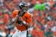 DENVER, CO - SEPTEMBER 29: Quarterback Peyton Manning #18 of the Denver Broncos rolls out of the pocket and looks for a receiver downfield against the Philadelphia Eagles at Sports Authority Field Field at Mile High on September 29, 2013 in Denver, Colorado. (Photo by Dustin Bradford/Getty Images)