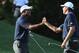 It was smiles and high-fives for Tiger Woods and Matt Kuchar.