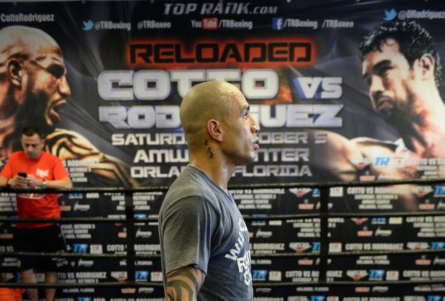 Hi-res-180973844-miguel-cotto-walks-around-the-ring-during-a-break-in_crop_north