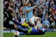 MANCHESTER, ENGLAND - OCTOBER 05: Sergio Aguero of Manchester City shoots past Sylvain Distin (R) and Tim Howard (L) of Everton to score his team's second goal during the Barclays Premier League match between Manchester City and Everton at Etihad Stadium on October 5, 2013 in Manchester, England. (Photo by Shaun Botterill/Getty Images)