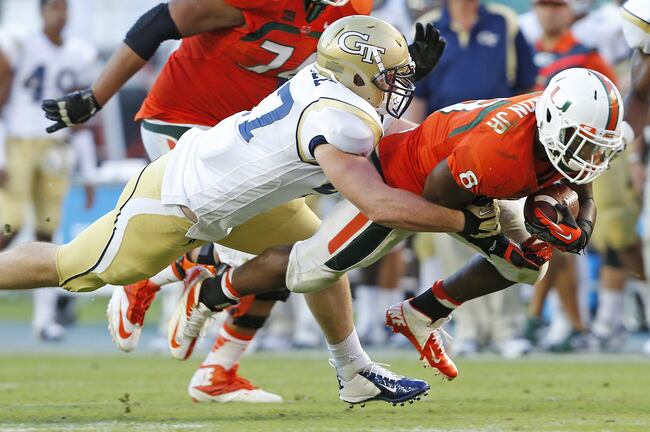 Hi-res-183178956-duke-johnson-of-the-miami-hurricanes-is-tackled-by_crop_north