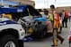 Oct 6, 2013; Kansas City, KS, USA; Crew members for NASCAR Sprint Cup Series driver Kyle Busch (18) work on the wrecked car during race action for the Hollywood Casino 400 at Kansas Speedway. Mandatory Credit: Mike DiNovo-USA TODAY Sports